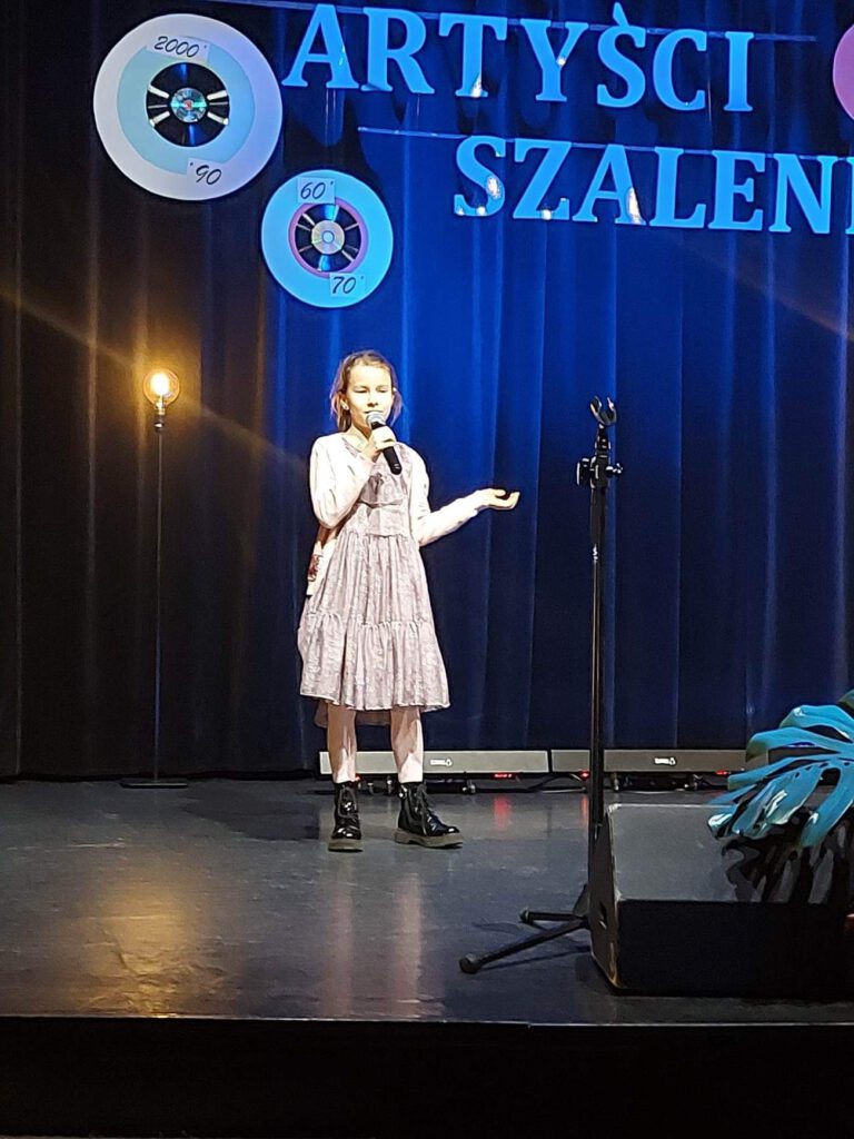 na zdjęciu uczennica klasy 2 a Lena Bartlewska w piosence „Co powie Tata”.