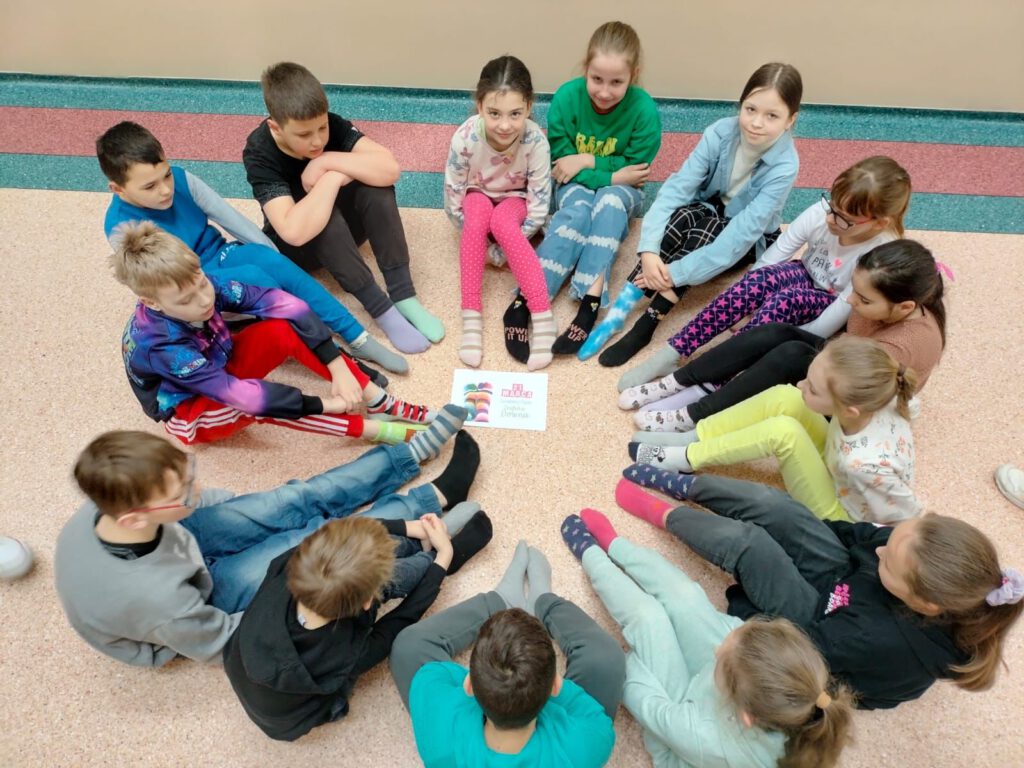  Na zdjęciu uczniowie klasy 3a pokazują swoje kolorowe skarpetki. 