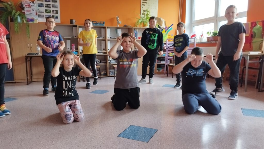 Projekt #ActiveSisterSchools. Na zdjęciu uczniowie wykonują różne figury taneczne. 