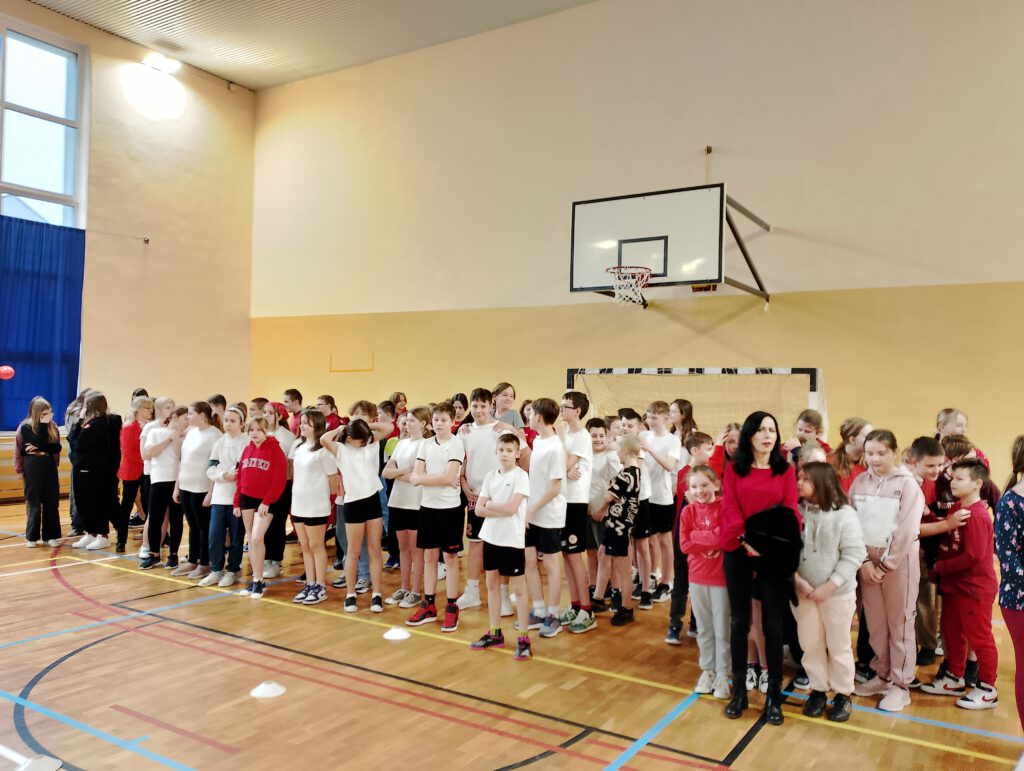 Walentynkowy turniej klas. Na zdjęciu uczniowie na sali gimnastycznej oczekujący na rozgrywki sportowe. 