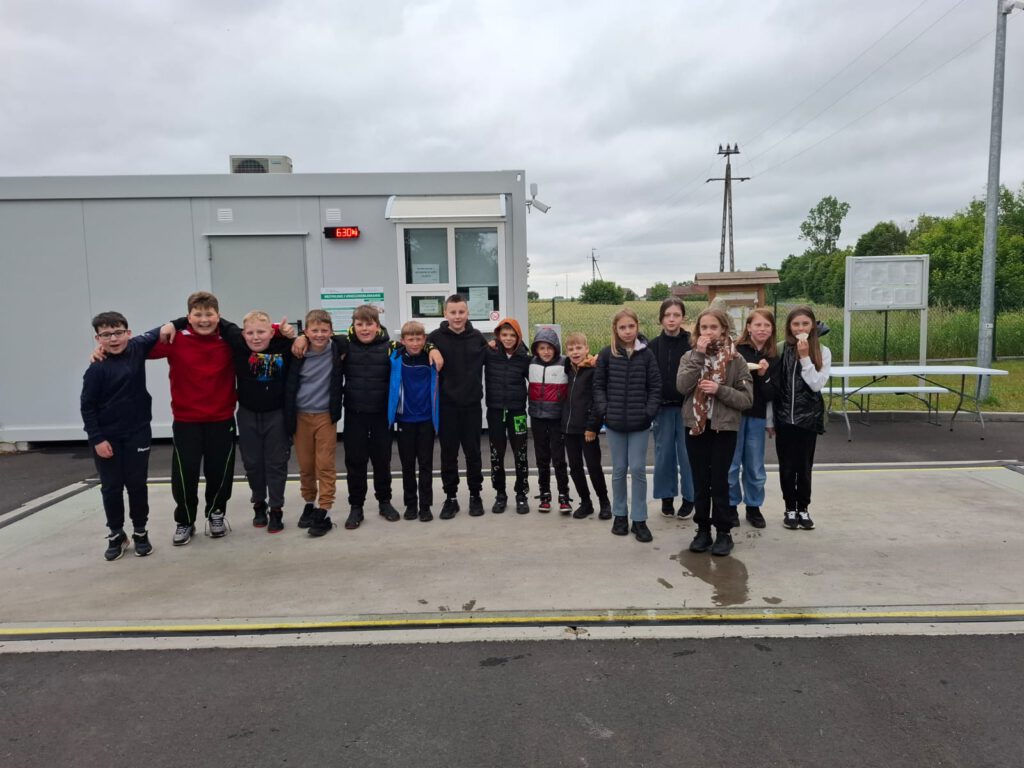 Projekt edukacyjny ,,Jestem w pSzoku”. Na zdjęciu uczestnicy warsztatów ,,Jestem w pSzoku" stojący na wadze (ile waży cała grupa).
