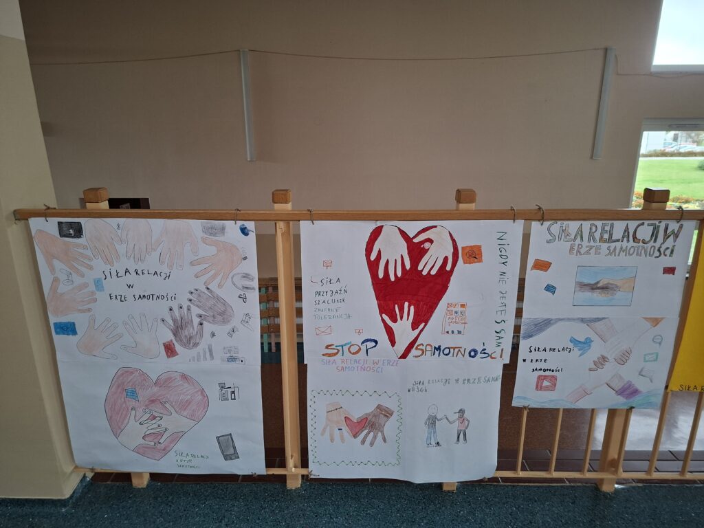 Przedstawia złączone dłonie na czerwonym sercu.