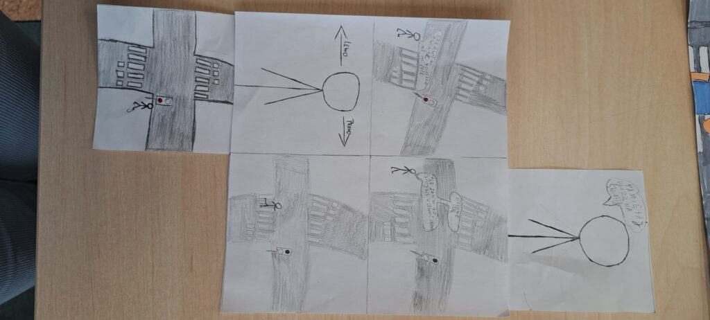 Odblaskowa szkoła 2025- komiksy uczniów. Na zdjęciu komiksy wykonane ręcznie prze uczniów w formie obrazkowej na temat bezpieczeństwa w ruchu drogowym, przy przechodzeniu przez jednię i stosowania zasad ruchu drogowego. 