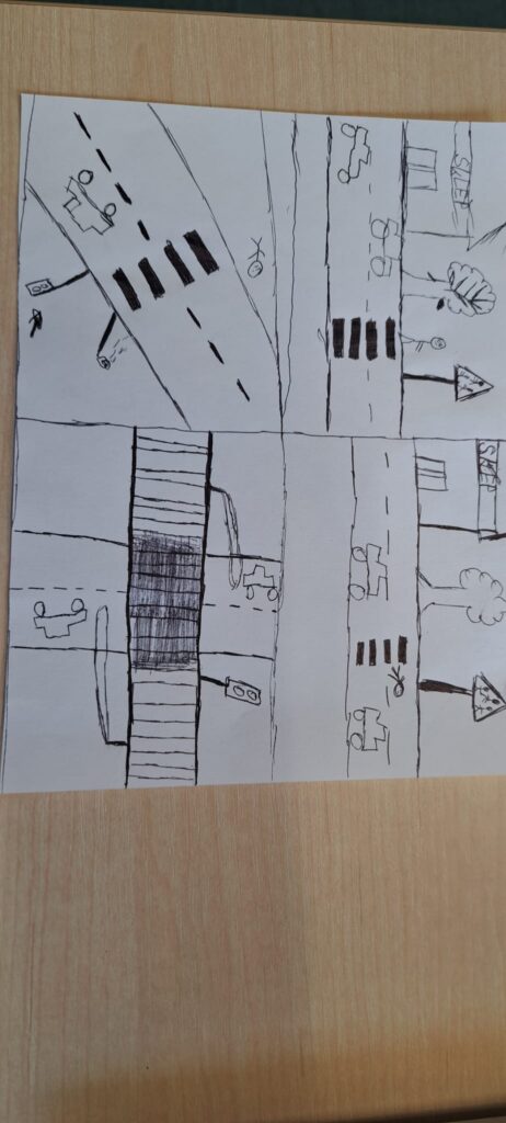 Odblaskowa szkoła 2025- komiksy uczniów. Na zdjęciu komiksy wykonane ręcznie prze uczniów w formie obrazkowej na temat bezpieczeństwa w ruchu drogowym, przy przechodzeniu przez jednię i stosowania zasad ruchu drogowego. 