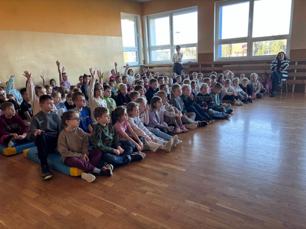 Na zdjęciu znajduje się grupa dzieci z klas 1 - 3 podczas spotkania z Policjantami.