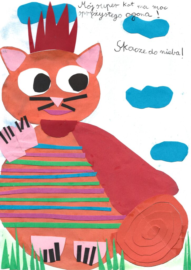Jedna z wyróżnionych pracy – rudy kot w kolorowe paski z długim ogonem w kształcie spirali. Praca wykonana techniką wycinanki. Podpisana następująco: „Mój super kot ma moc sprężystego ogona! Skacze do nieba!”.